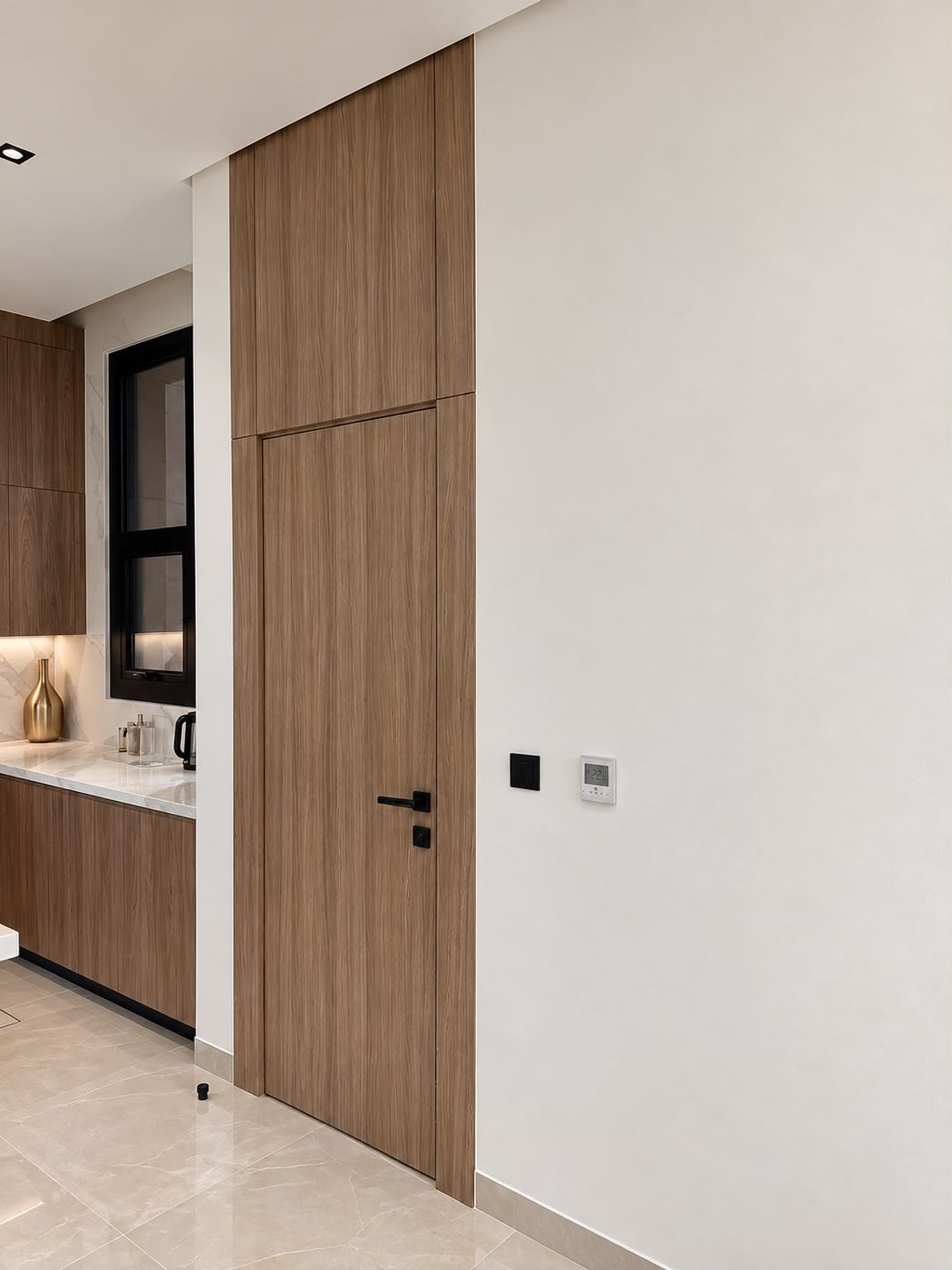 Flush walnut door with a matching overpanel beside fitted kitchen units