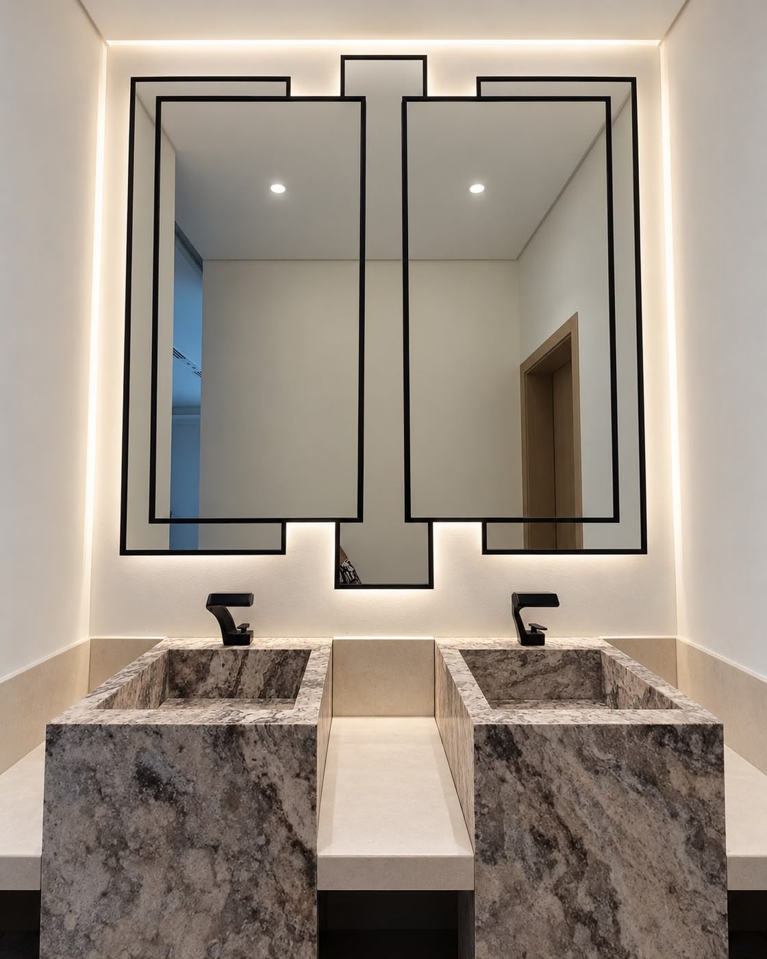 Pair of black-framed backlit mirrors above twin marble basins